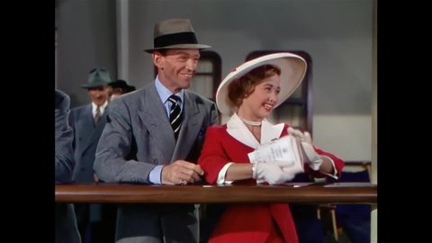 CIRCA 1951 - A brother (Fred Astaire) and sister departing on a cruise ship watch as her boyfriends fight over saying goodbye to her on the dock.