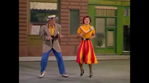 CIRCA 1951 - In this musical, a man (Fred Astaire) and woman tap dance on stage in colorful costumes.