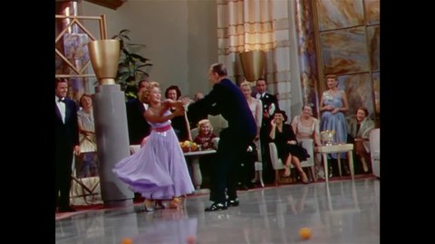 CIRCA 1951 - In this musical, a man (Fred Astaire) and his dance partner must nimbly avoid instruments and furniture that slip across the dance floor.