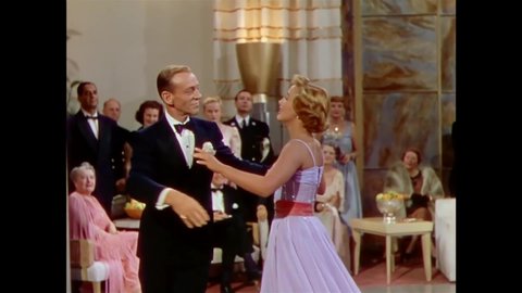 CIRCA 1951 - In this musical, a woman sings at a fancy party and begins to dance with a man (Fred Astaire).