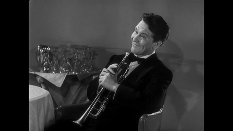CIRCA 1940 - In this musical, a trumpet player (Fred Astaire) gets his ex-girlfriend's attention with a loud solo while she dances.