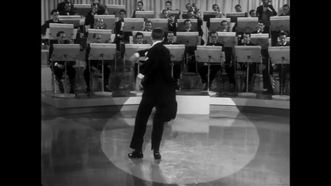 CIRCA 1940 - In this musical, a bandleader (Fred Astaire) dances while he conducts on stage.