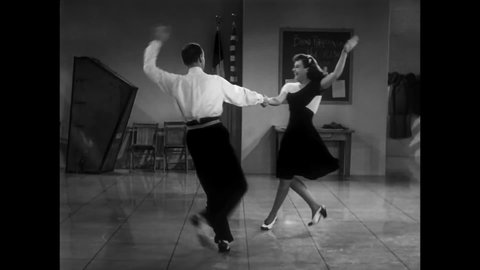 CIRCA 1940 - In this musical, a man (Fred Astaire) finishes a dance with the girl he likes in a rehearsal space with a jazz band.