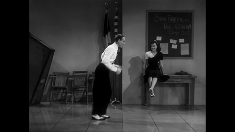 CIRCA 1940 - In this musical, a man (Fred Astaire) dances with the girl he likes in a rehearsal space with a jazz band.