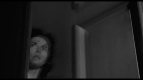 CIRCA 1958 - In this horror film, a woman opens the door at night to find only a skull, which makes her scream and faint in fright.