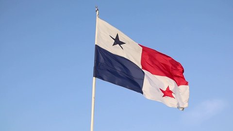 The Flag of Panama, fluttering in a blue summer sky