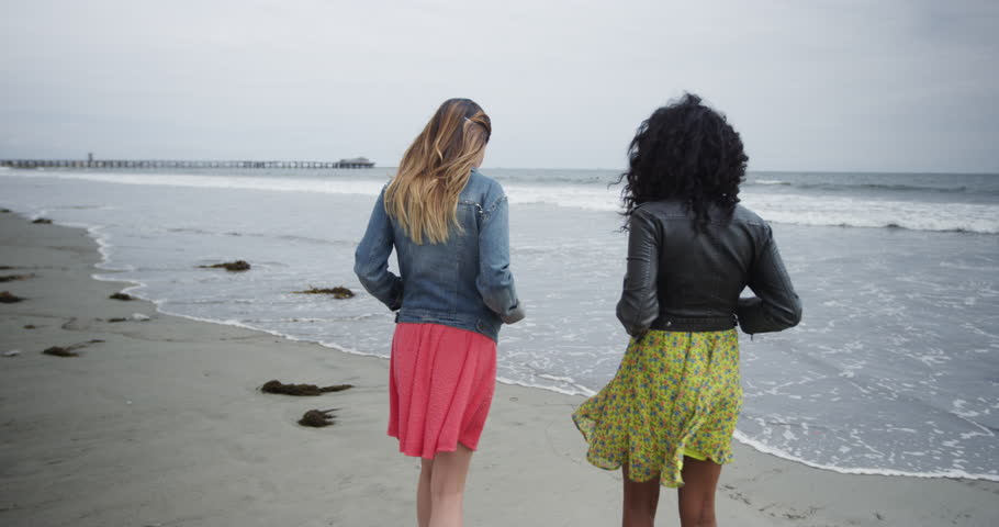 Beautiful women standing by the ocean