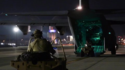 CIRCA 2020 Special operations soldiers load ATVs onto a cargo transport plane during exercise Gryphon Jet, Yokota Air Base.