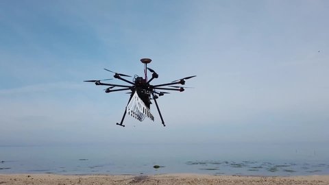CIRCA 2021 Aerial drone footage of high technology, ground penetrating radar Sky Glass mounted on a drone, flys test patterns on a beach in Kiel.