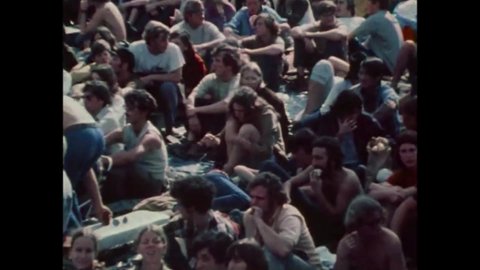 CIRCA 1971 - In this exploitation movie, a rock band drowns out a preacher at an outdoor gathering for hippies.