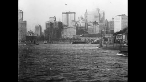 CIRCA 1920s - Ships arrive and leave the Manhattan port in 1921. The Brooklyn Bridge is visible.