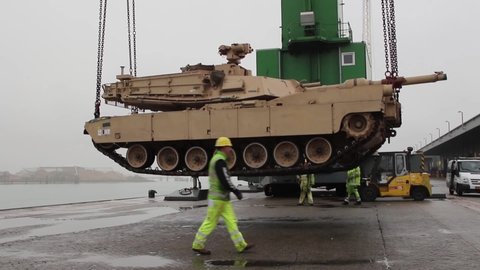 CIRCA 2019 598th Transport Brigade supervises loading an M1A2 Abrams tank into a low barge at Vlissingen, Netherlands.