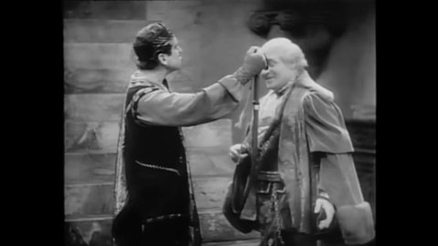 CIRCA 1929 - In this adaptation of Shakespeare's Taming of the Shrew, Petruchio readies himself to meet Katherine and she greets him with a whip.