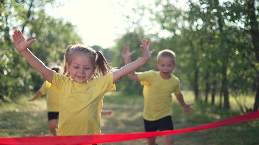 Kid are run. Child run through forest park to finish line. Victory and Success. Kid is winner. Happy child run in forest park. Baby run to finish line. Boy path to success and victory. Child winner Royalty-Free Stock Footage #1075783769