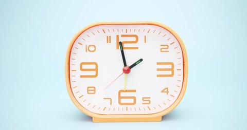 Close up detail - Orange Alarm clock isolated on blue background Showtime 02.00 am or pm , Time lapse 2 hour.