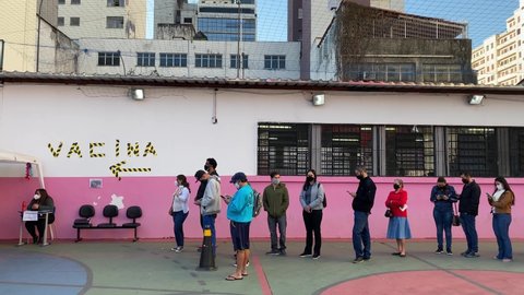 Sao Paulo, SP, Brazil - July 12, 2021: People wait in line to get vaccinated against COVID-19 during a priority vaccination program for people with more than 37 years old.