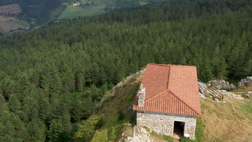 Aerial drone view of the hermitage of Aitzorrotz on top of a mountain in the Basque Country
