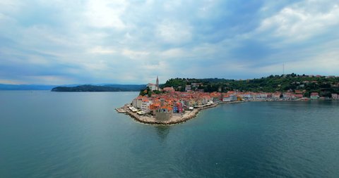 Aerial Piran city flight from the sea to church in Slovenia in Europe in HDR
