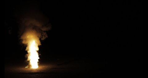 Gunpowder fuse burning and smoking at night