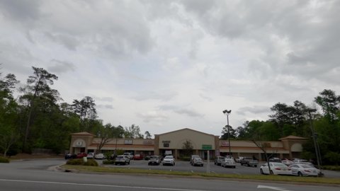 Columbia County, Ga USA - 04 10 21: Time-lapse Suburban retail shopping center strip mall Music store Dollar General - Belair road