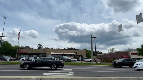 Augusta, Ga USA - 04 15 21:  Street pan of a busy shopping district with retail strip malls and restaurants - Robert C Daniel Parkway 