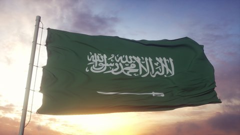 Flag of Saudi Arabia waving in the wind against deep beautiful sky at sunset