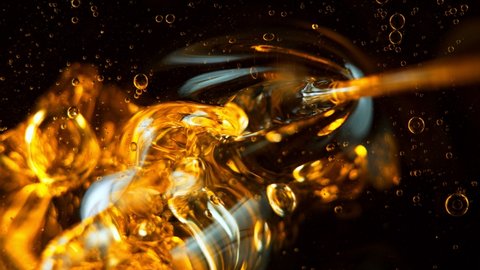 Super Slow Motion Shot of Pouring Oil Isolated on Black Background at 1000fps.