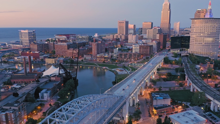 Aerial flying over downtown Cleveland, Cuyahoga river  the Flats at sunset, Ohio, USA Royalty-Free Stock Footage #1075850159