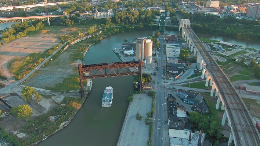 Aerial: Cuyahoga river and ferry boat at sunset. Cleveland, Ohio, USA