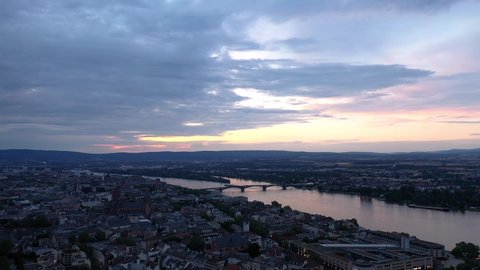 Sky over Mainz with a drone aerial at magic hour night circling with the cathedral and the dark Rhine river water in the background showing a colorful sky