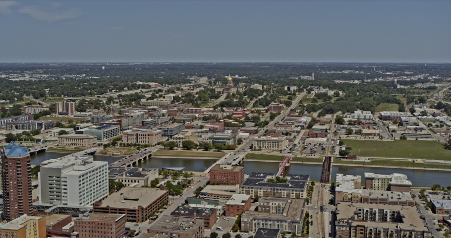 Des Moines Iowa, descending aerial over downtown crossing the river towards the Capitol Building - 6k professional footage - August 2020