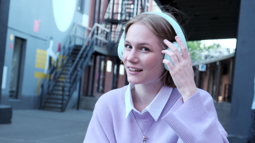 Happy woman looking at web camera waving hand and greeting. Online conversation by videocall. Vlogger starting livestream, recording video for social media.
