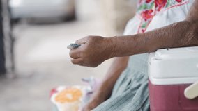 artisan woman hands holding mexican pesos