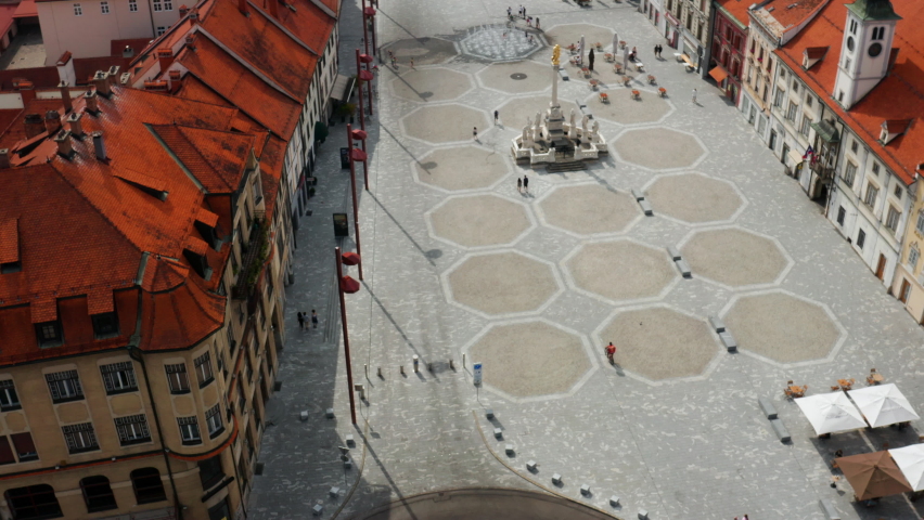 Aerial View Of Few People At Main Square With Plague Column Monument In Slovenia. Royalty-Free Stock Footage #1075861013