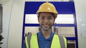 Video footage of a female engineer or foreman standing smiling.