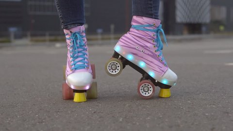 Woman's legs in a vintage quad roller skates with LED lights. Slow motion. 스톡 비디오