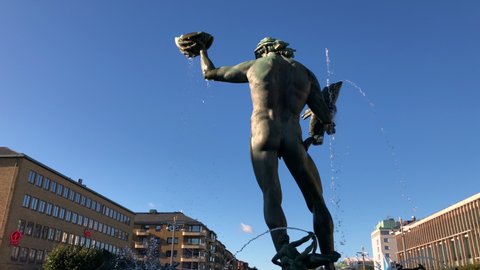 Gothenburg, Sweden - September 28 2018: The Statue Poseidon in Gothenburg, Sweden. Filmed from behind the statue. Calm Swedish summer day.
