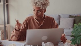 Stressed African business woman sit at home desk with laptop and crumpled papers, feels tired take off glasses having concentration problem, lack of ideas writer block creative crisis deadline concept - Powered by Shutterstock - Get 15% off with code: PIKWIZARD15