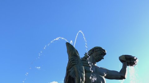 Gothenburg, Sweden - September 28 2018: The Poseidon statue in Gothenburg Sweden. Tilting down from head to toe. Bright blue sky in the background. Summer day in Sweden.
