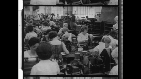 1960s Toledo, OH. Mature Women working in Factory. Gray Hair Women assemble Machine Parts.  4K Overscan of Vintage Archival Black and White 16mm Film Footage 