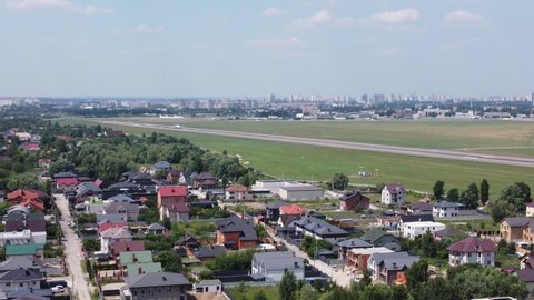 Plane takeoff. A small airport on the outskirts of the city