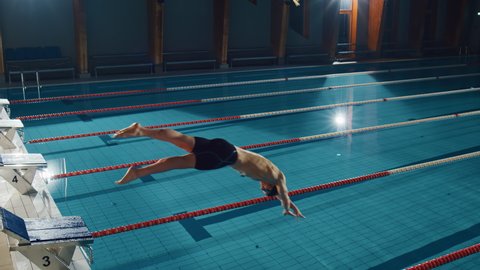 Muscular Male Swimmer Diving in Swimming Pool. Professional Athlete Gracefully Jumps. Training Determined to Win Championship. Cinematic Light, Slow Motion with Stylish Colors, Artistic Aerial