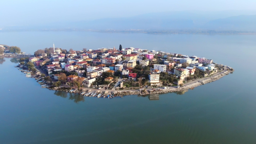 Houses covering the entire peninsula.Village on chersonese.Aerial peninsula on the sea.Peninsular seaside coast near side blue sunny island isle autumn cinematic city town house bursa turkey golyazi 