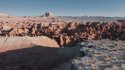 Drone flying low above ancient Colorado plateau. Red Mars planet landscapes, cinematic geological wonder in the rocky desert in Utah, USA. Aerial of the edge of the world, view of another planet 4K