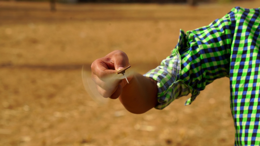 Little girl playing with turbine toy at the wind turbine field with fun together. Child girl enjoy with beautiful scenery view of nature.