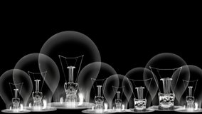 Light bulbs going from dark to light with Career, Success, Motivation, Skill and Development fiber text on black background. High quality 4k video.