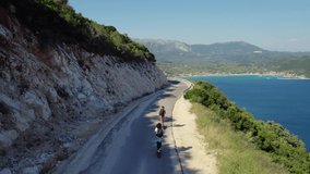 Couple man and woman on the Electric Scooter Aerial seaside scene in 4K Aerial Drone Shot. - Powered by Shutterstock - Get 15% off with code: PIKWIZARD15
