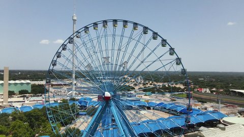 Dallas, Texas \ USA 07-13-2021 Aerial Drone Footage of Texas Star Ferris Wheel in Dallas Fair Park on a sunny Summer day