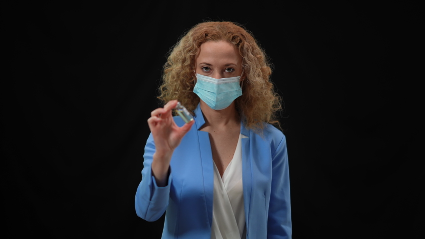 Portrait of serious Caucasian woman in coronavirus face mask talking showing Covid-19 vaccine jab. Confident politician or doctor explaining importance of vaccination in fight with pandemic Royalty-Free Stock Footage #1075901555