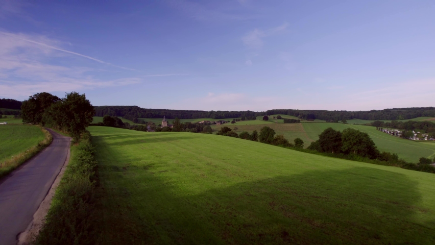 Over the rolling hills, meadows with woodlands, wooded banks and rural roads. Beusdael Castle in the background, in South Limburg near the three-country point Vaals and Maastricht the Netherlands